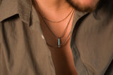 man wearing silver chains