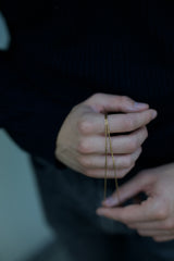 gold wire bracelet around hand detail