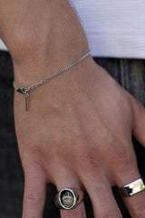 man wearing silver link bracelet around wrist