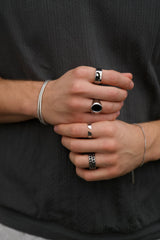man wearing banded silver ring