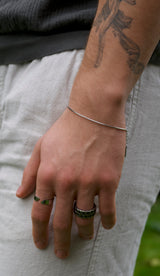 man wearing silver boxed chain bracelet