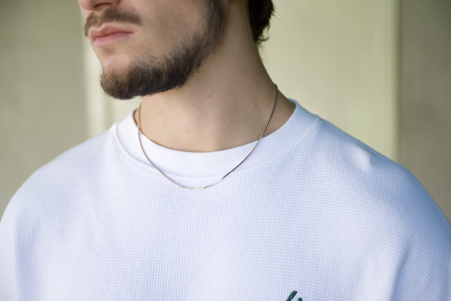 silver chain on white t-shirt