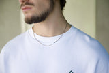 silver chain on white t-shirt