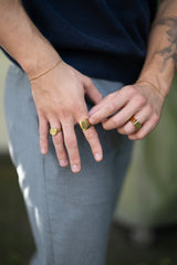 man wearing square gold ring