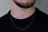 gold wire chain over black shirt